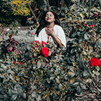 smiling woman amid roses
